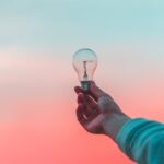 person-holding-light-bulb
