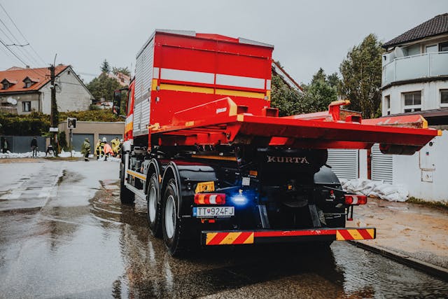 red-tow-truck-in-urban-setting-on-rainy-day-
